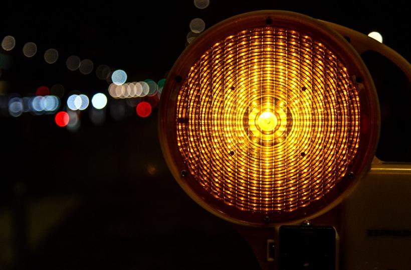 Amber construction warning light glowing at night